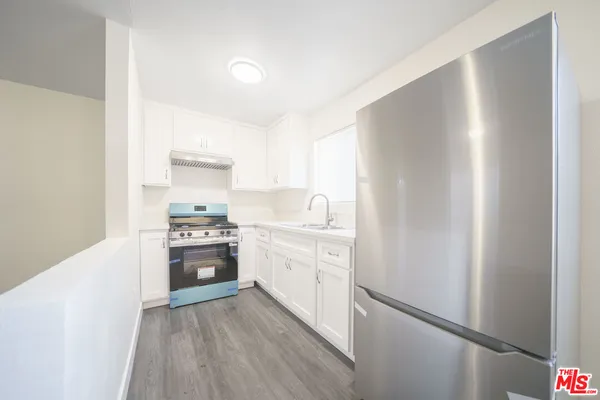 a kitchen with a refrigerator stove and sink