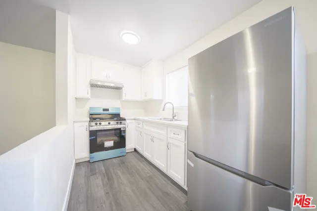 a kitchen with a refrigerator stove and sink
