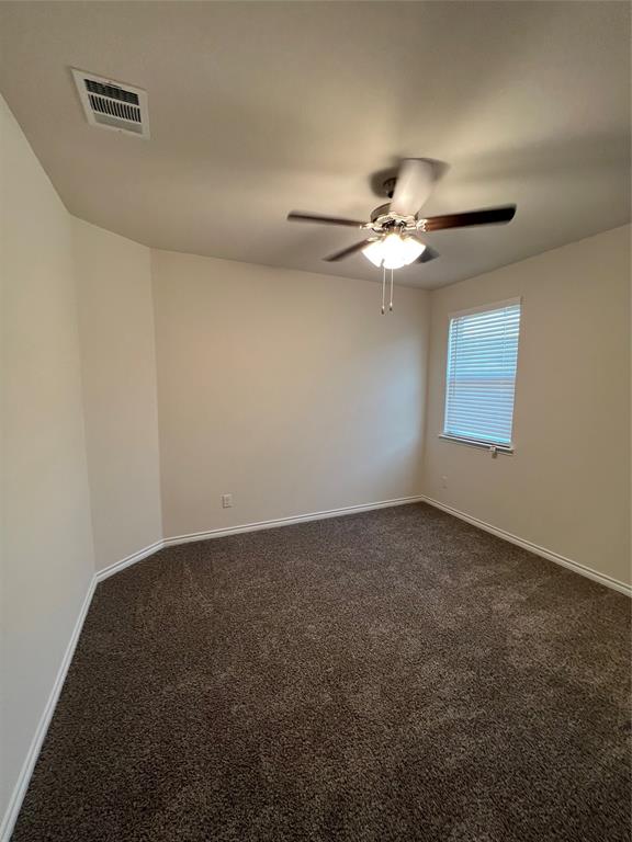 11005 Mustang Trail Aubrey, TX 76227 - Photo 3 of 6 an empty room with windows and chandelier fan