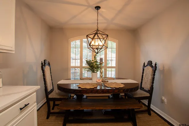 a view of a dining room with furniture and window