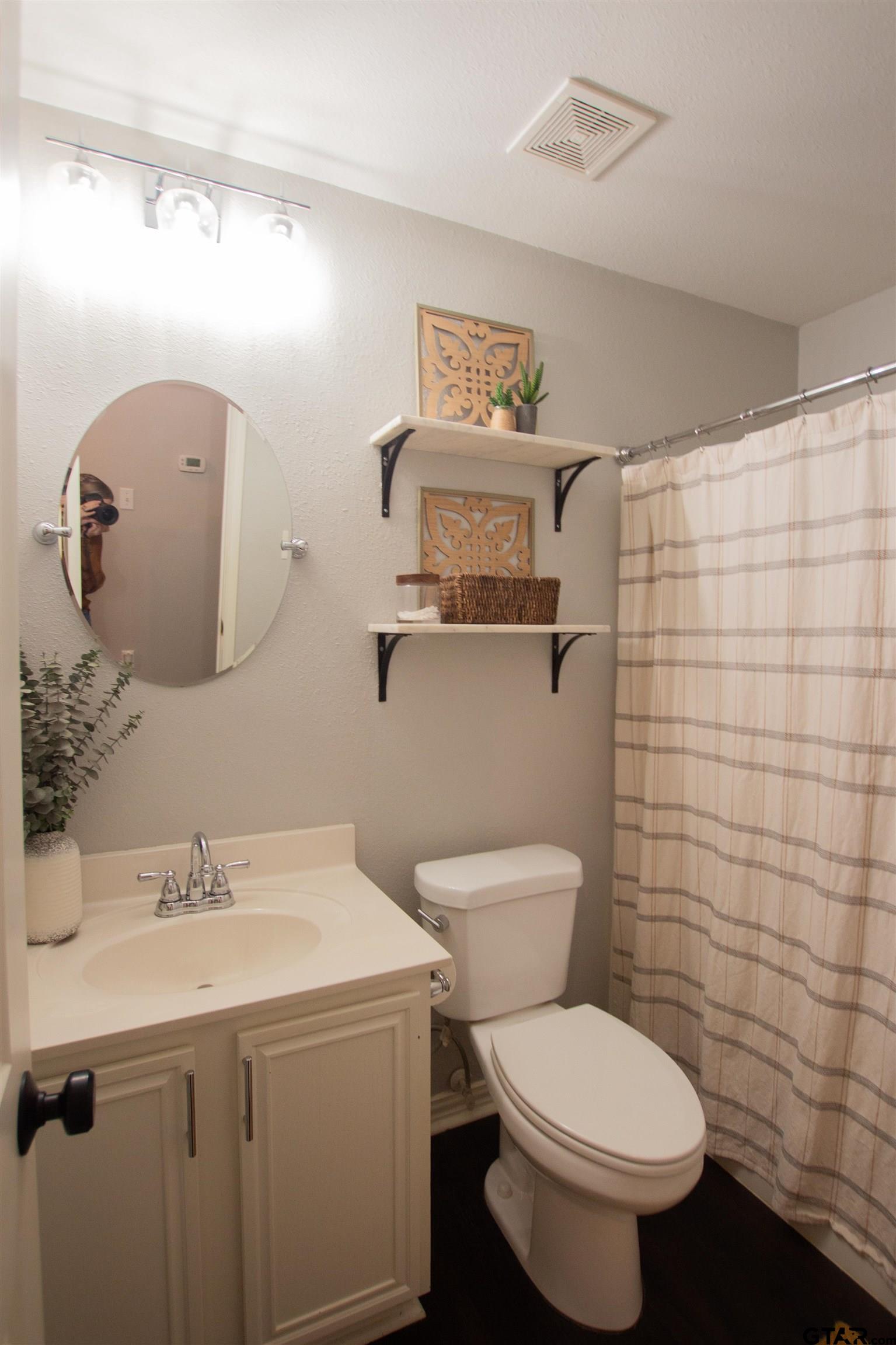 551 Frederick Circle Flint, TX 75762 - Photo 14 of 24 a bathroom with a toilet sink and mirror