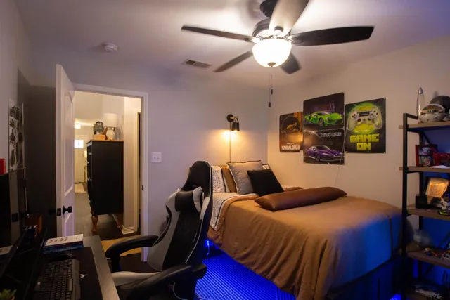 a bedroom with a bed and a chandelier