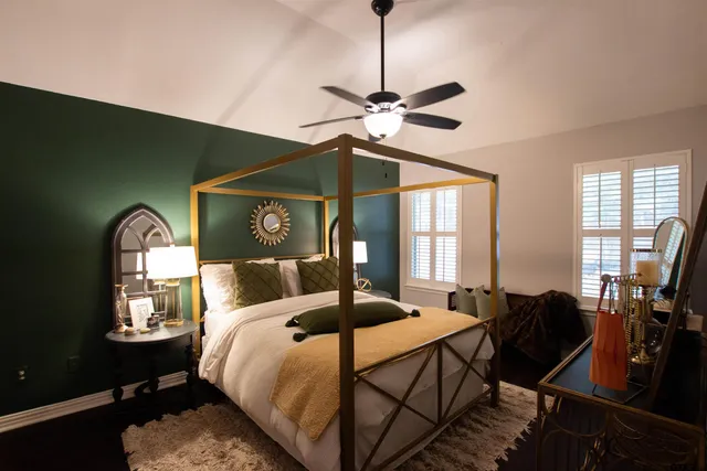 a bedroom with a bed window and dresser