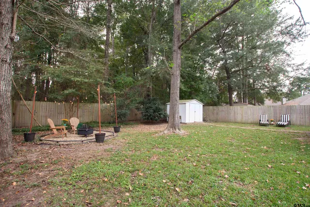 a backyard of a house with table and chairs