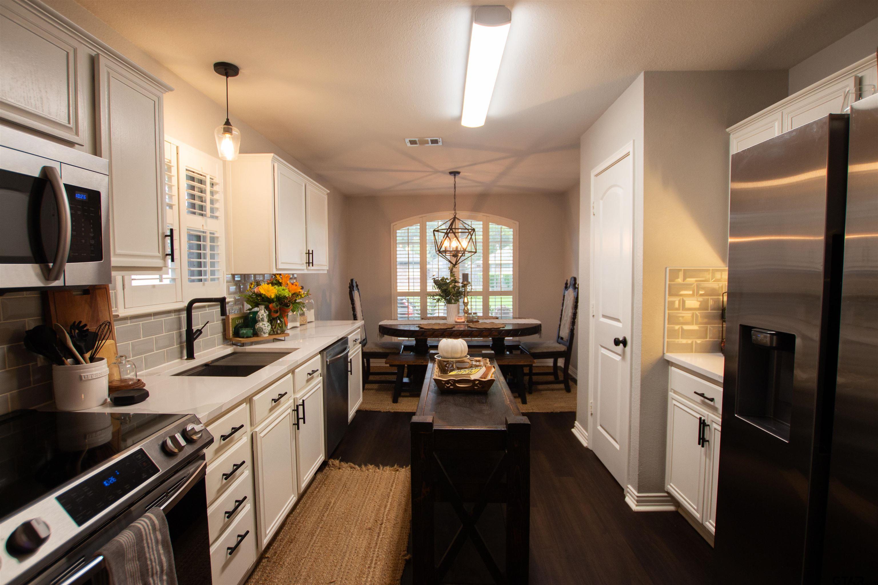 551 Frederick Circle Flint, TX 75762 - Photo 6 of 24 a kitchen with stainless steel appliances sink stove microwave and cabinets