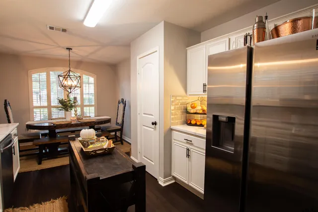 a kitchen with refrigerator and window