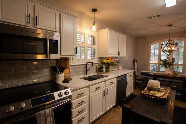 a kitchen with a stove a sink and a microwave