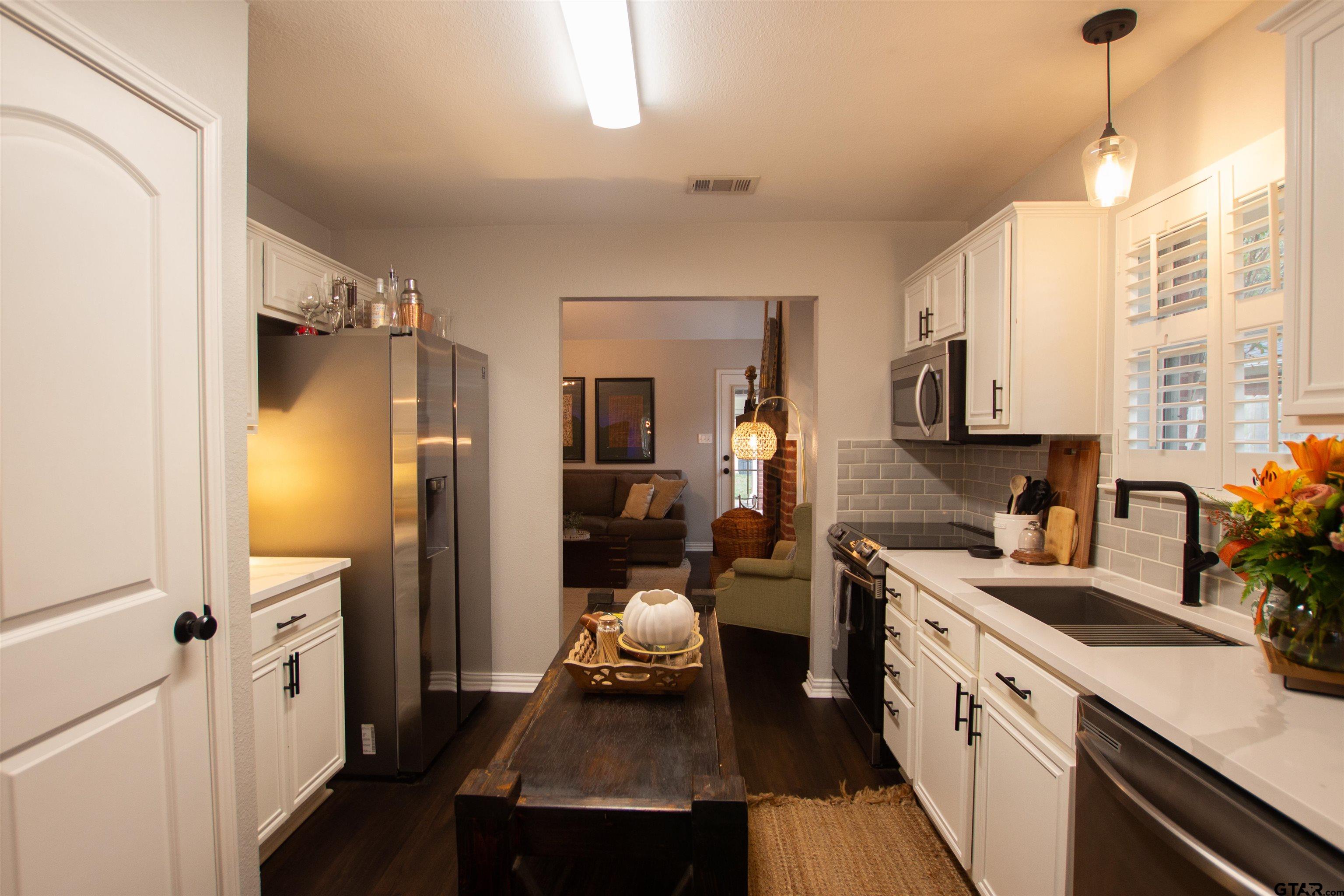 551 Frederick Circle Flint, TX 75762 - Photo 9 of 24 a kitchen with a refrigerator and a sink
