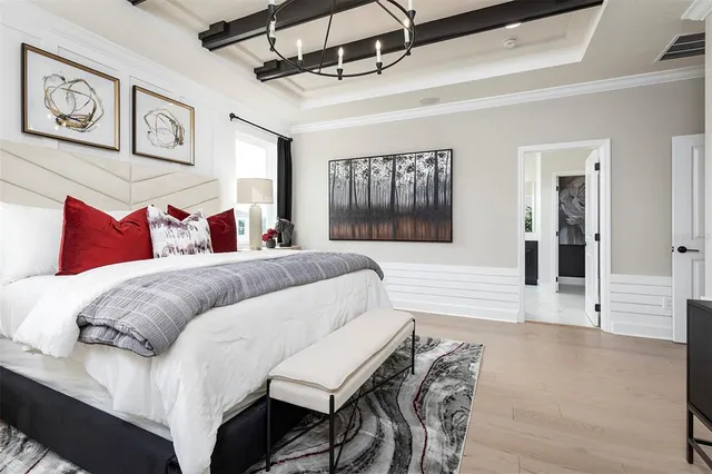 a bed room with a bed a couch and painting on the wall