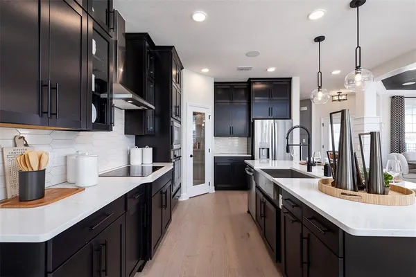 a kitchen with refrigerator and chairs