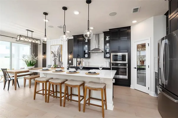 a kitchen with a table and chairs in it