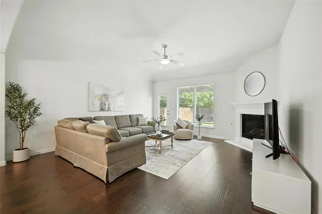 a living room with furniture a fireplace and a potted plant