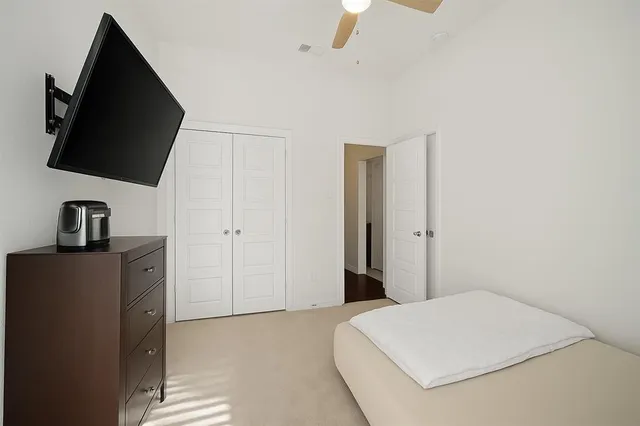 a bedroom with a bed and a flat screen tv