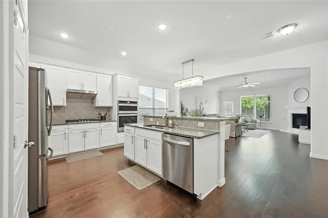 a kitchen with a stove a sink and a refrigerator