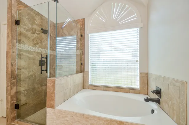 a bathroom with a bathtub and a shower