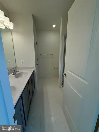 a bathroom with a sink a mirror and a shower