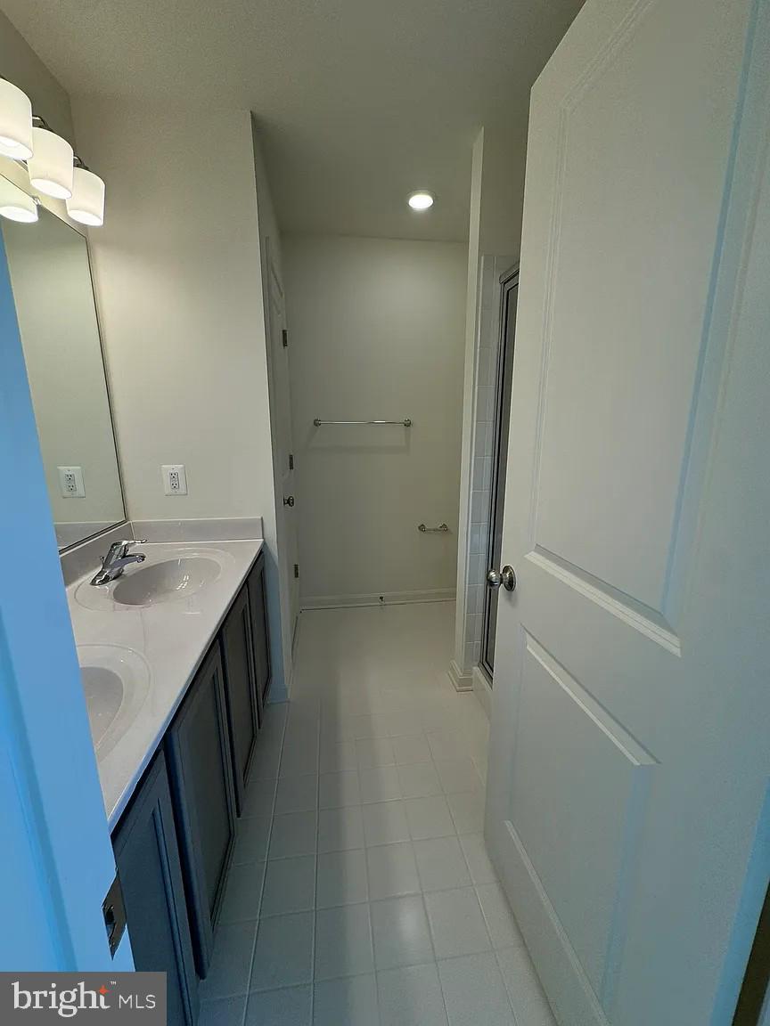 318 Appleby School Road Cambridge, MD 21613 - Photo 5 of 10 a bathroom with a sink a mirror and a shower