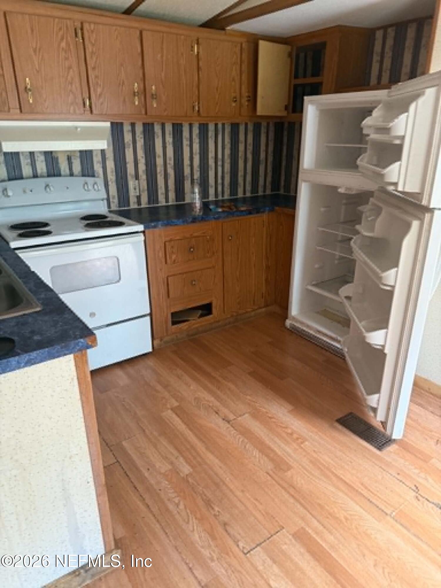112 Cindy Street Interlachen, FL 32148 - Photo 2 of 2 a view of kitchen and wooden floor