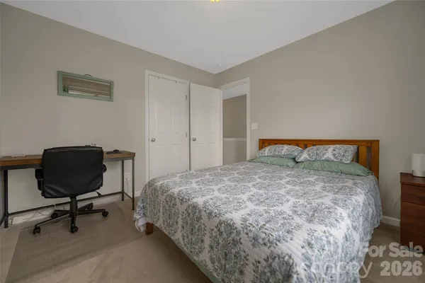 a bedroom with furniture and a flat tv screen