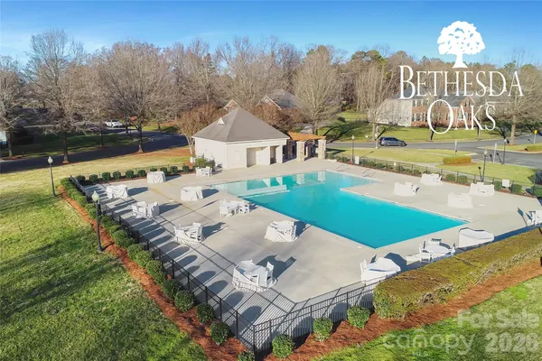 a view of swimming pool with outdoor seating and yard