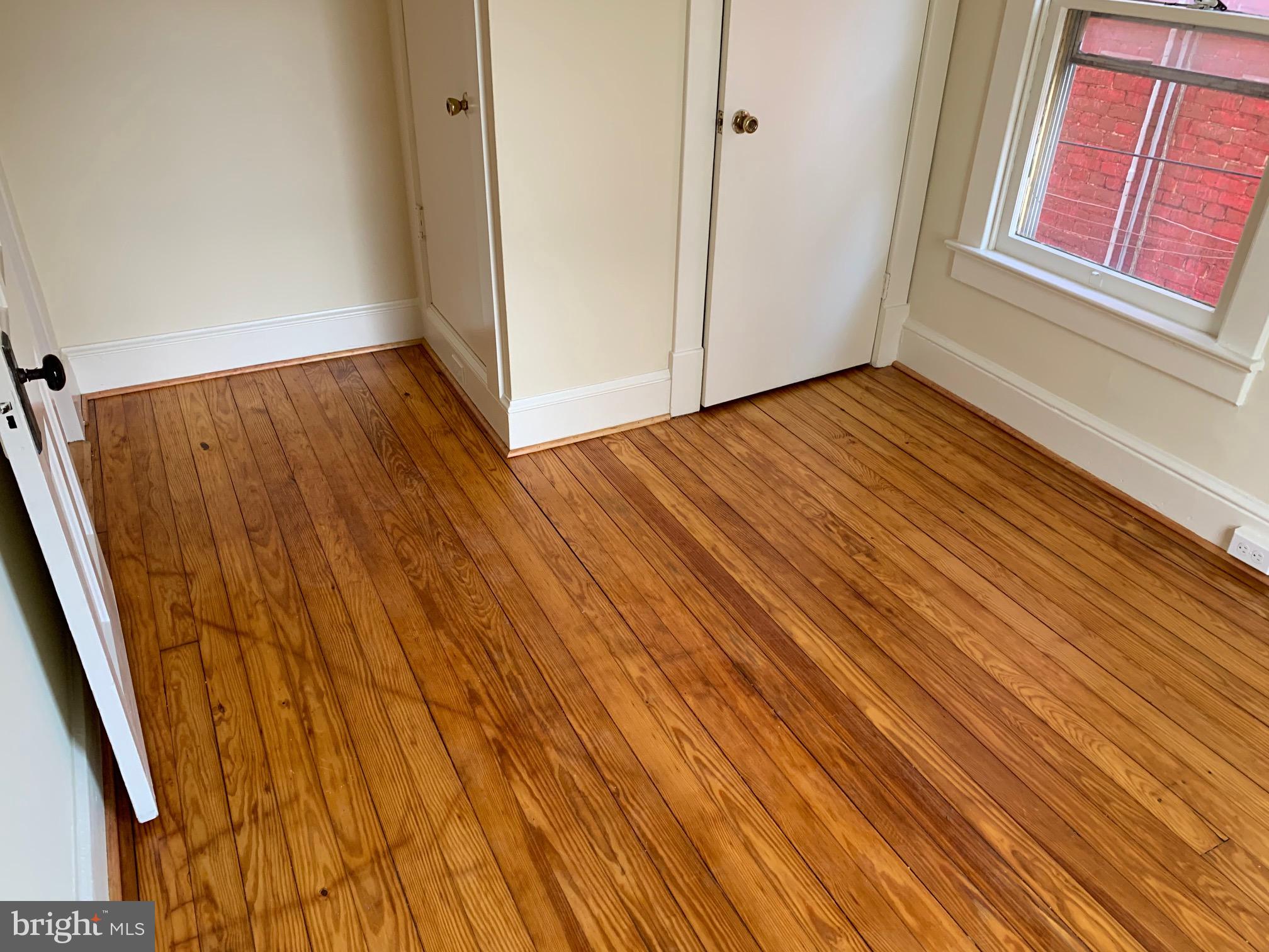 130 East German Street, Unit 201 Shepherdstown, WV 25443 - Photo 11 of 23 a view of an empty room with wooden floor and a window