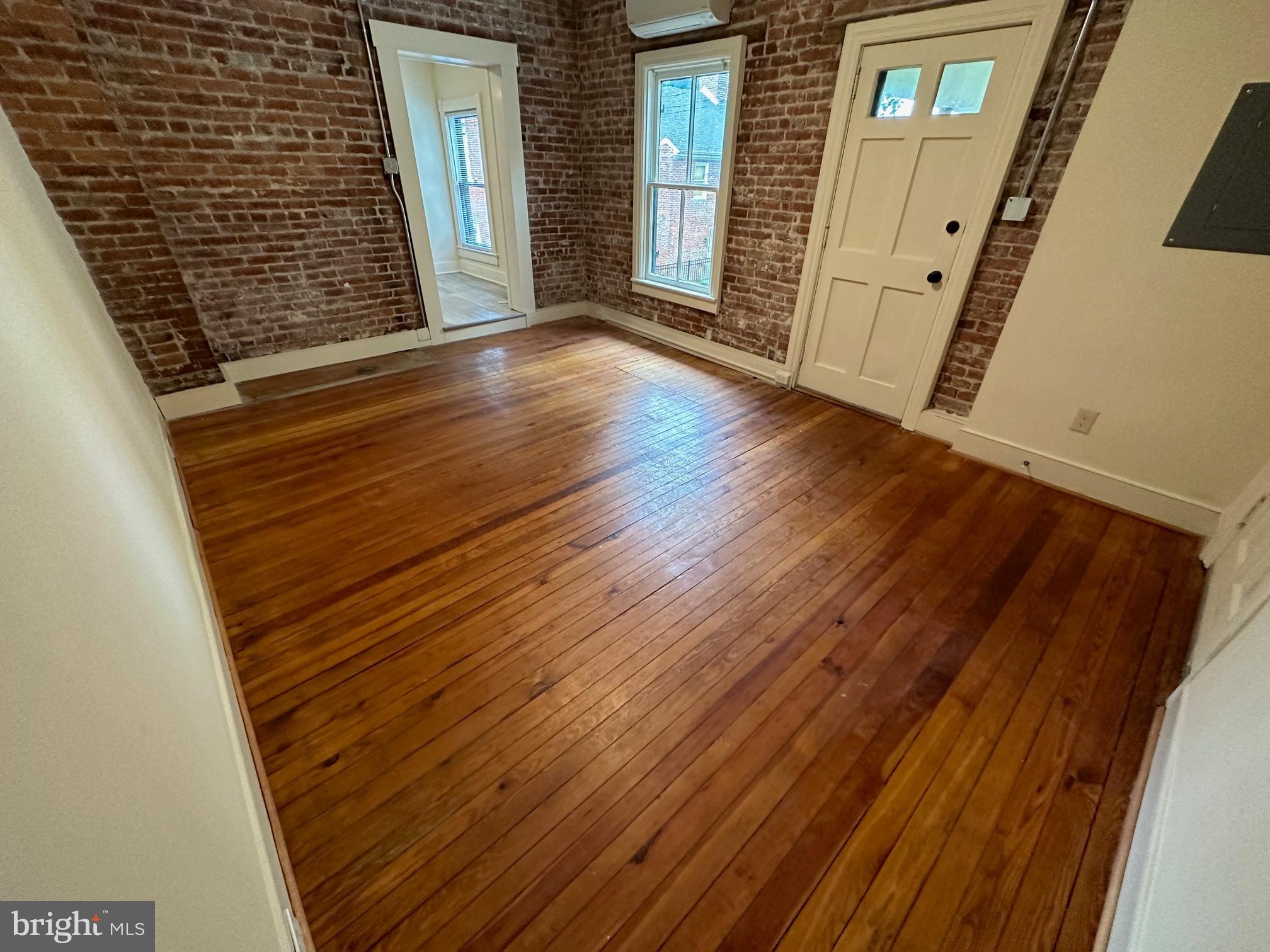 130 East German Street, Unit 201 Shepherdstown, WV 25443 - Photo 5 of 23 a view of a hallway with wooden floor and staircase
