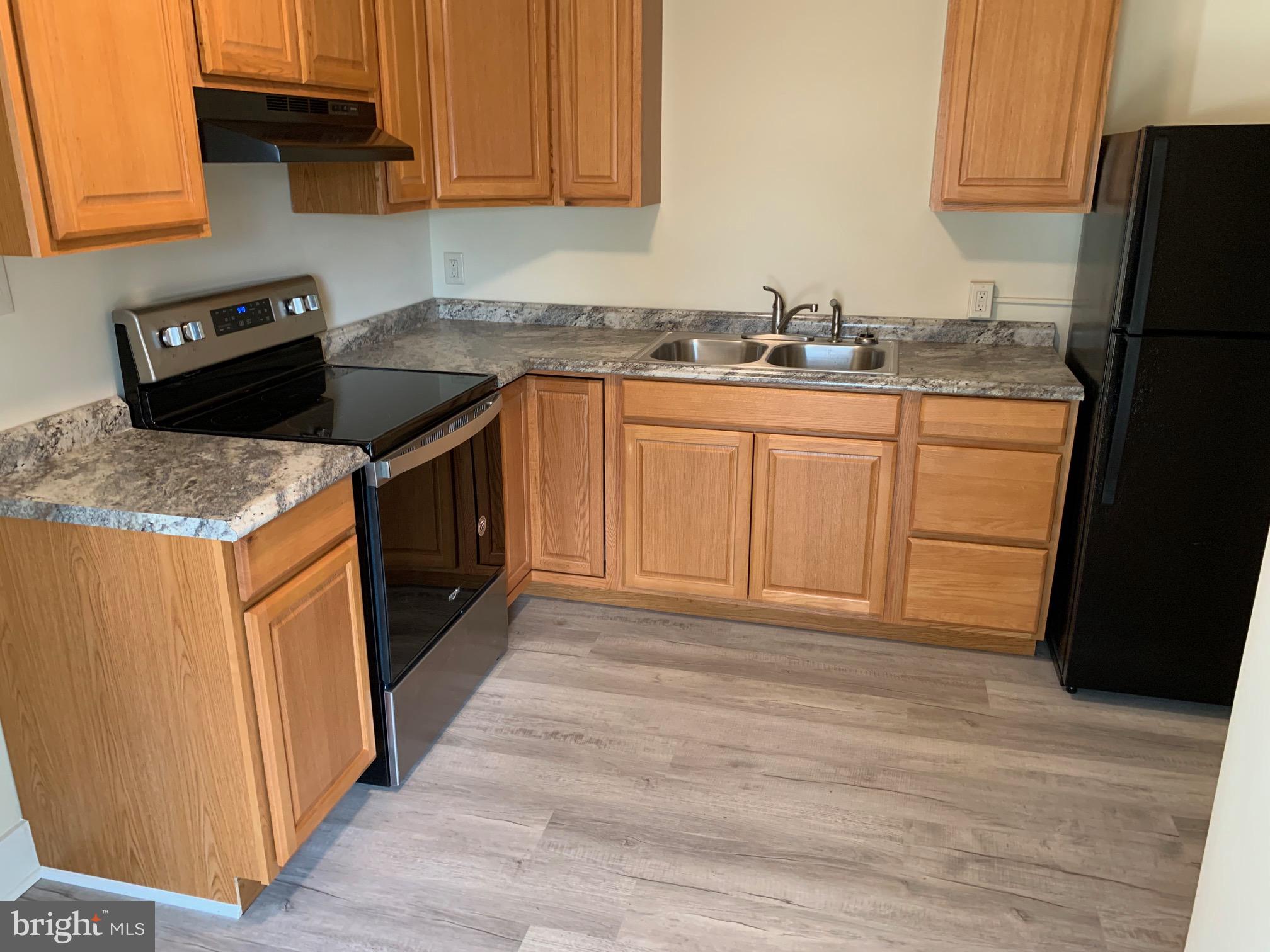 130 East German Street, Unit 201 Shepherdstown, WV 25443 - Photo 10 of 23 a kitchen with stainless steel appliances granite countertop a sink stove and refrigerator