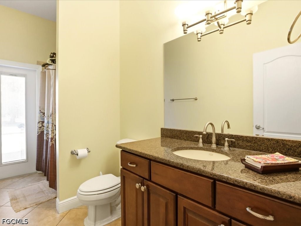 21651 Tuckahoe Road Alva, FL 33920 - Photo 12 of 42 a bathroom with a granite countertop sink toilet and shower