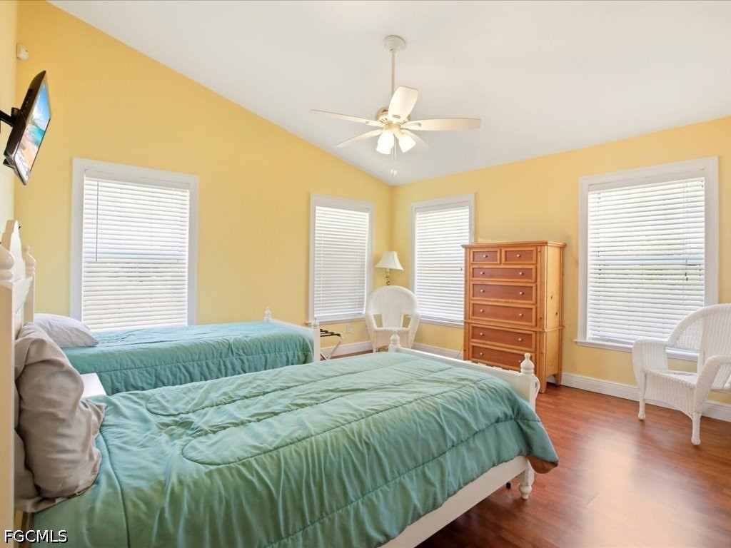 21651 Tuckahoe Road Alva, FL 33920 - Photo 14 of 42 a bedroom with a bed and a chandelier