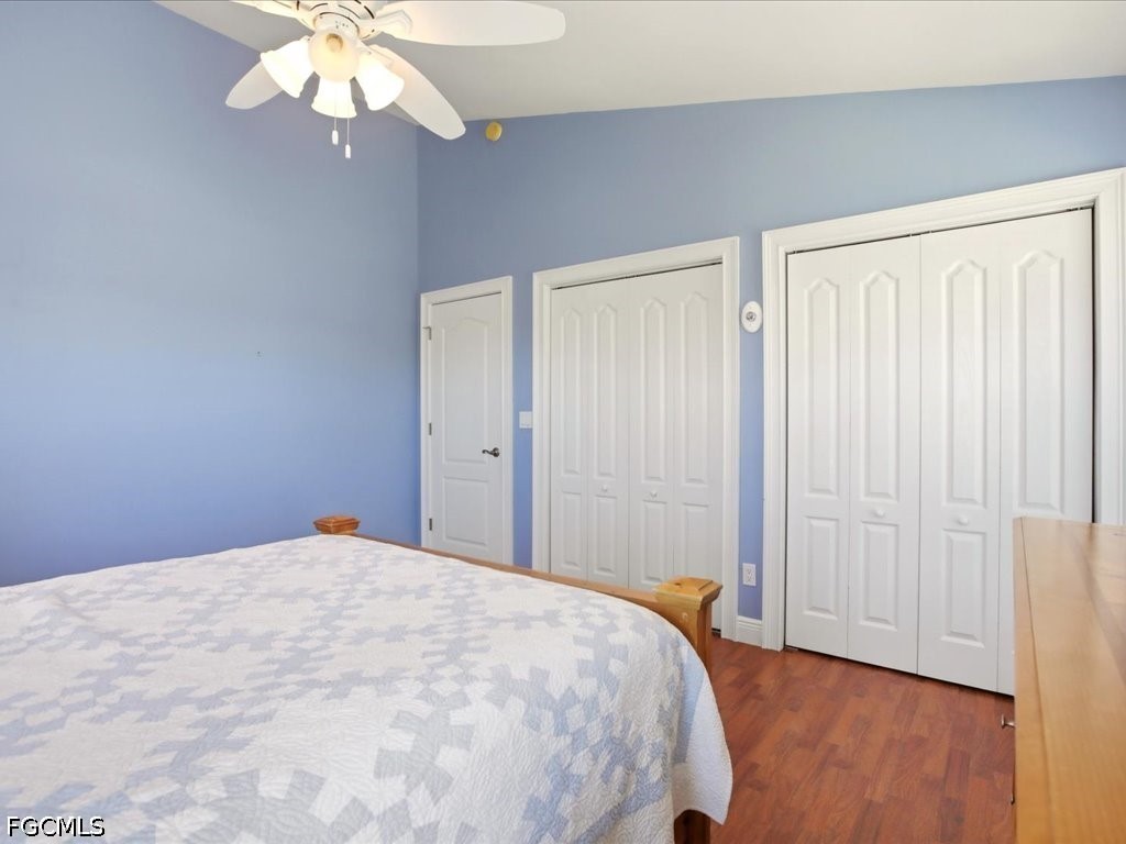 21651 Tuckahoe Road Alva, FL 33920 - Photo 17 of 42 a bedroom with a large bed and a chandelier