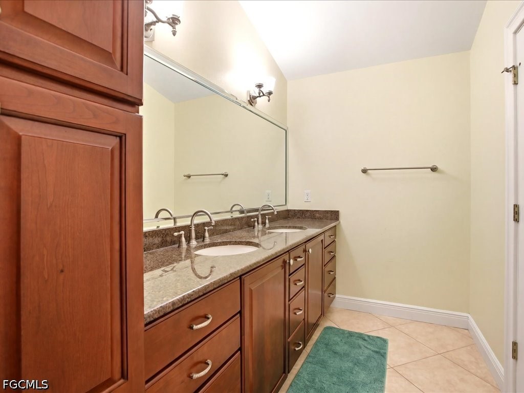 21651 Tuckahoe Road Alva, FL 33920 - Photo 20 of 42 a bathroom with a double vanity sink and mirror