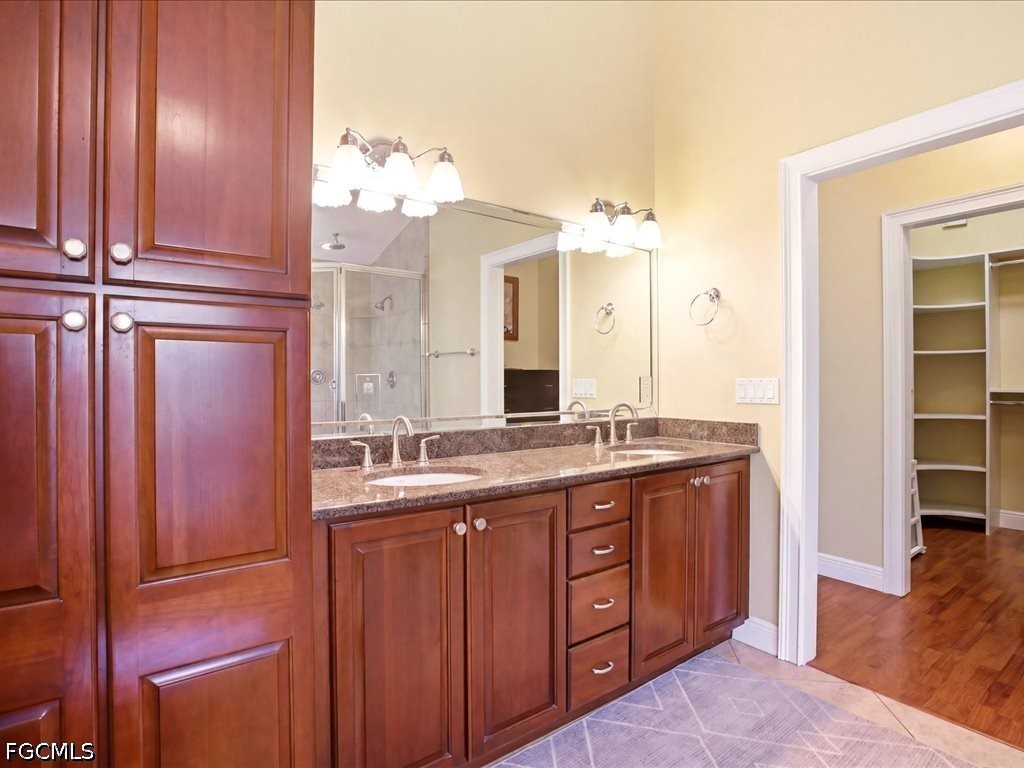 21651 Tuckahoe Road Alva, FL 33920 - Photo 26 of 42 a bathroom with a granite countertop sink and a mirror