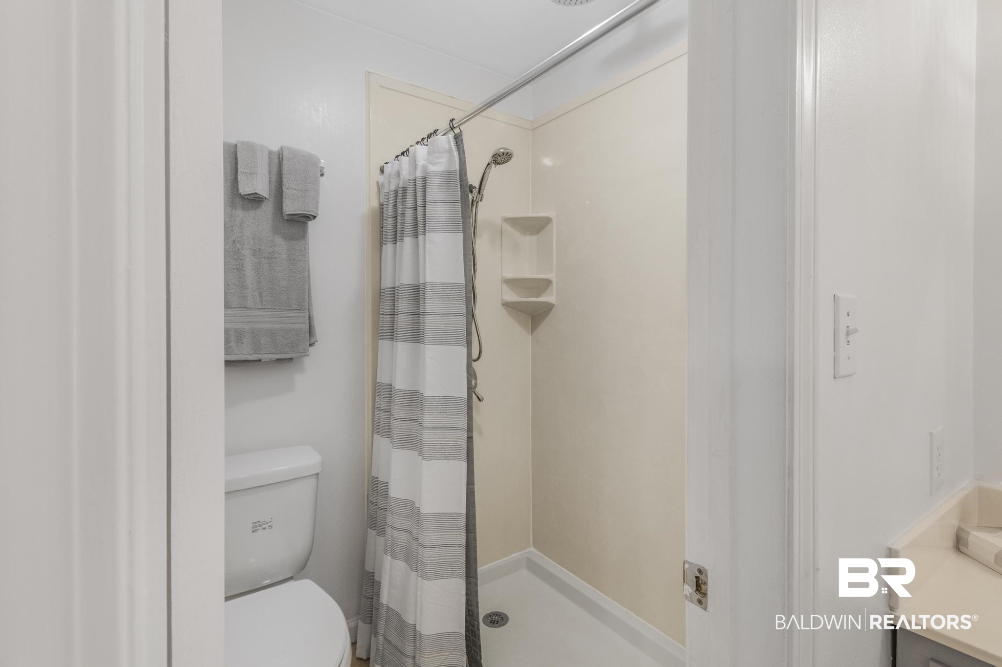 110 5th Street, Unit A 103 Daphne, AL 36526 - Photo 19 of 28 Bathroom with vanity, toilet, and a shower with curtain