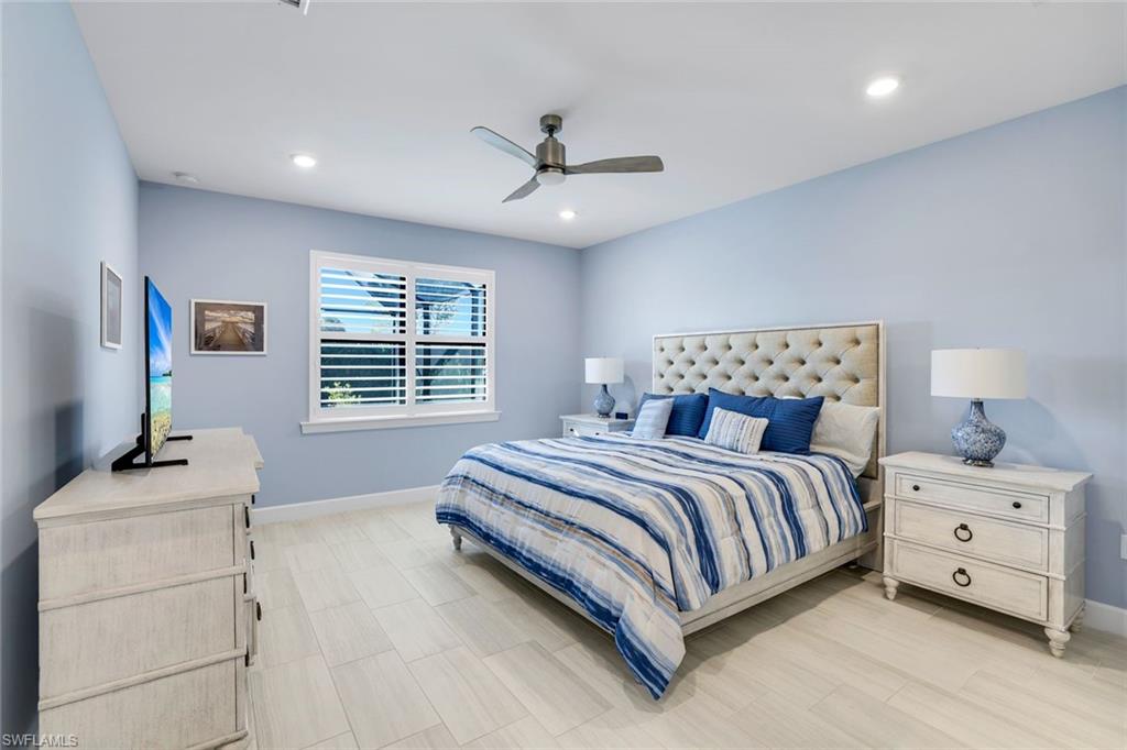 1944 Yellowfin Circle Naples, FL 34114 - Photo 16 of 36 a bedroom with a bed and a flat screen tv