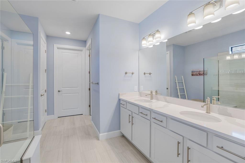 1944 Yellowfin Circle Naples, FL 34114 - Photo 18 of 36 a spacious bathroom with a double vanity sink mirror and shower