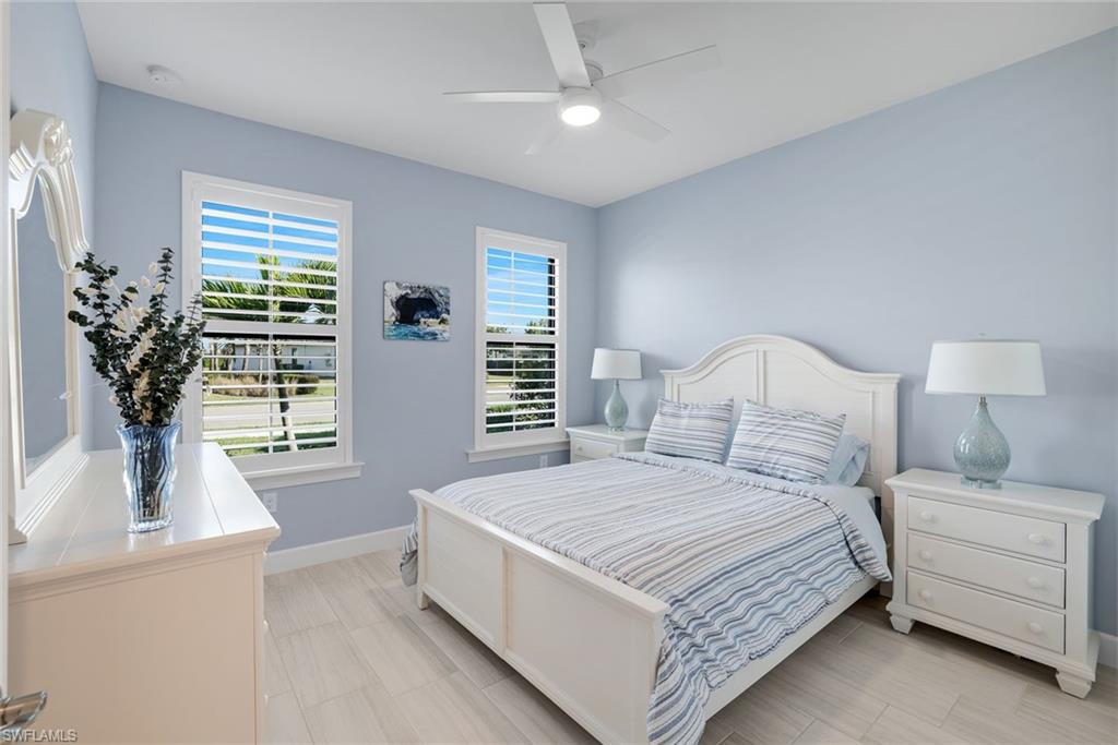 1944 Yellowfin Circle Naples, FL 34114 - Photo 20 of 36 a bedroom with a large bed and a window