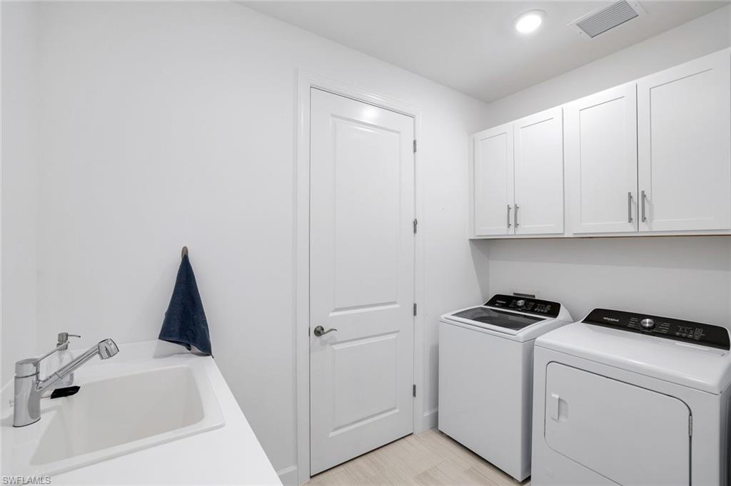 1944 Yellowfin Circle Naples, FL 34114 - Photo 24 of 36 a view of storage and utility room with washer and dryer