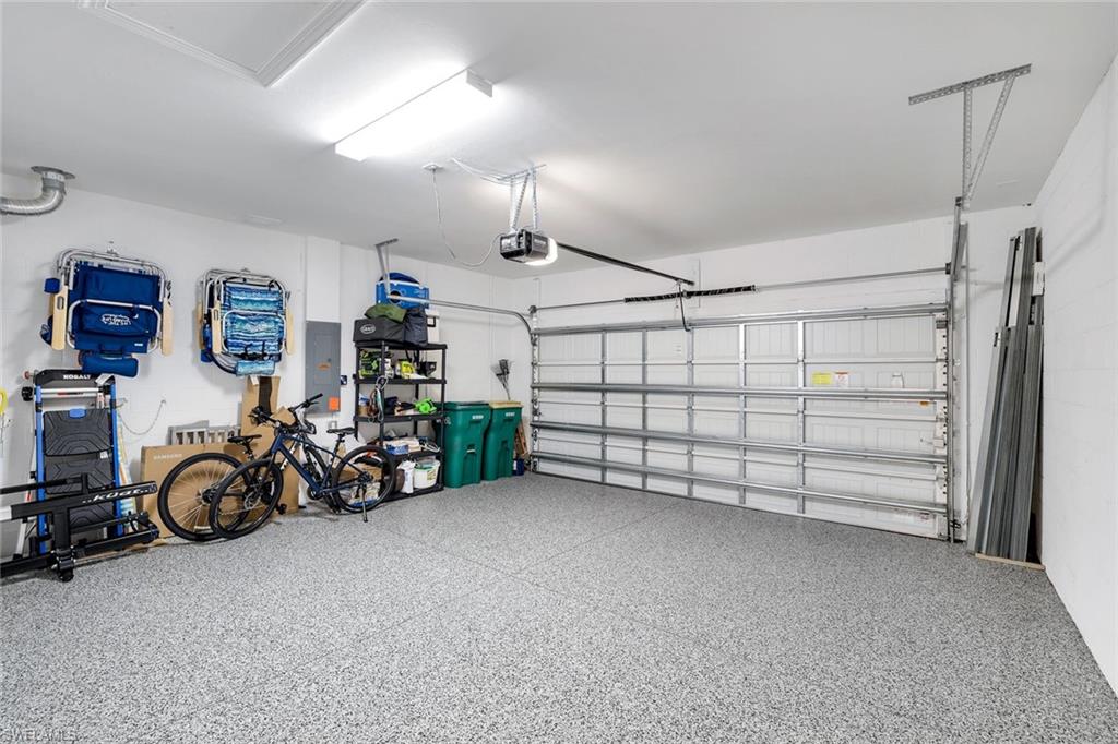 1944 Yellowfin Circle Naples, FL 34114 - Photo 25 of 36 a view of a garage with rack and bicycle