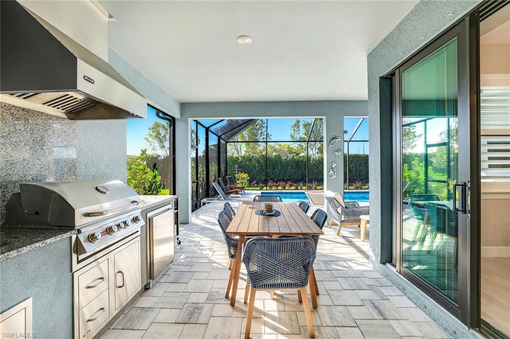 1944 Yellowfin Circle Naples, FL 34114 - Photo 6 of 36 a large white kitchen with a large window and furniture