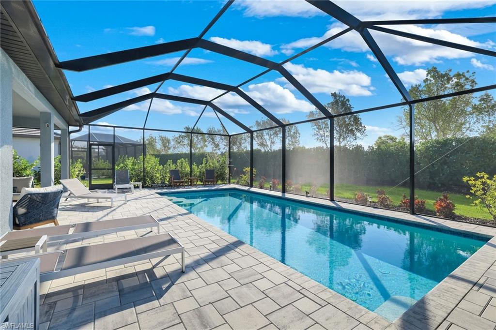 1944 Yellowfin Circle Naples, FL 34114 - Photo 8 of 36 a view of a patio with a table and chairs under an umbrella