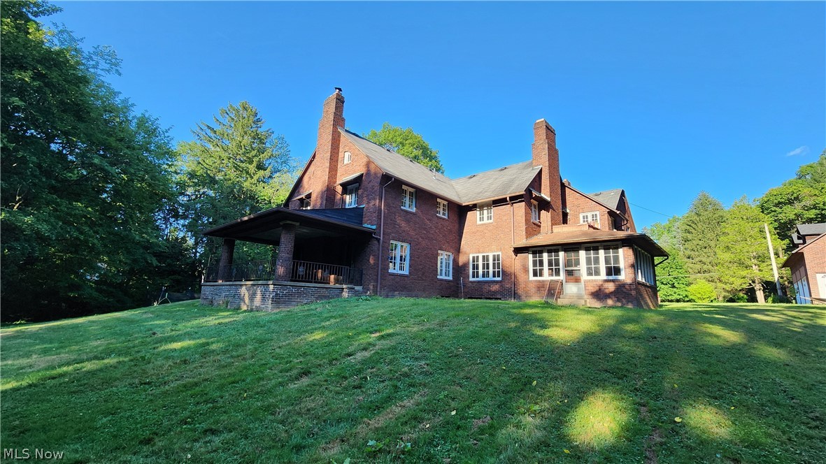 Rear view of property featuring a lawn