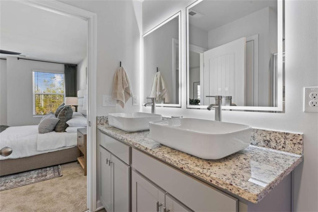 211 Ivey Terrace Temple, GA 30179 - Photo 23 of 26 a bathroom with sinks granite countertop a sink and a mirror