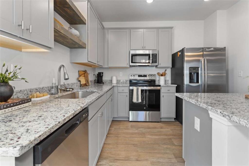 211 Ivey Terrace Temple, GA 30179 - Photo 8 of 26 a kitchen with stainless steel appliances granite countertop a sink stove and refrigerator