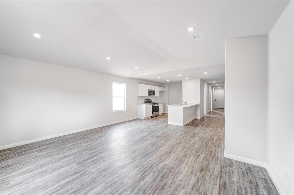 307 Victory Drive Mabank, TX 75147 - Photo 24 of 31 a view of empty room with wooden floor and window