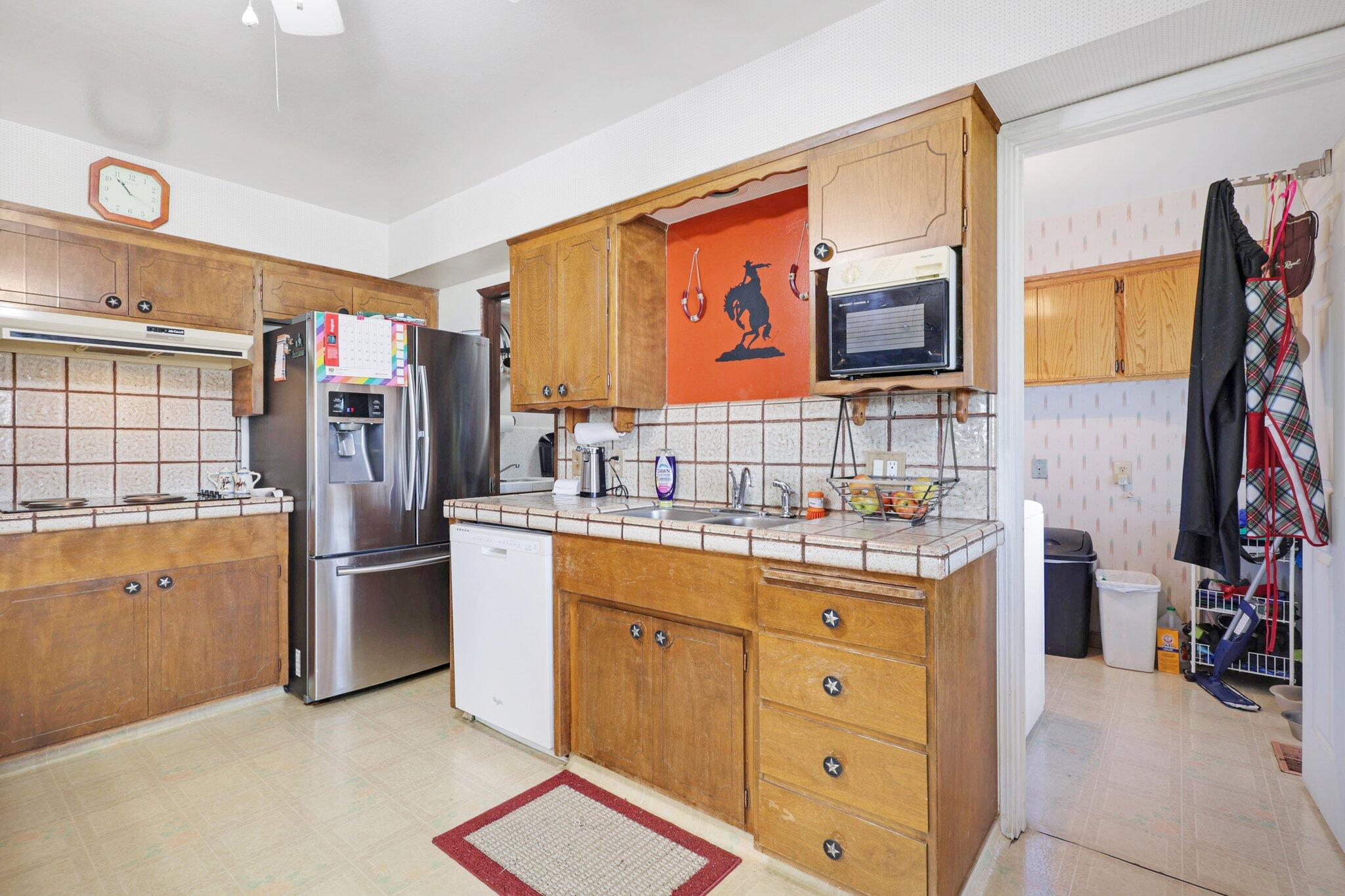 5078 Balls Ferry Road Anderson, CA 96007 - Photo 23 of 113 a kitchen with stainless steel appliances granite countertop a refrigerator and a stove top oven