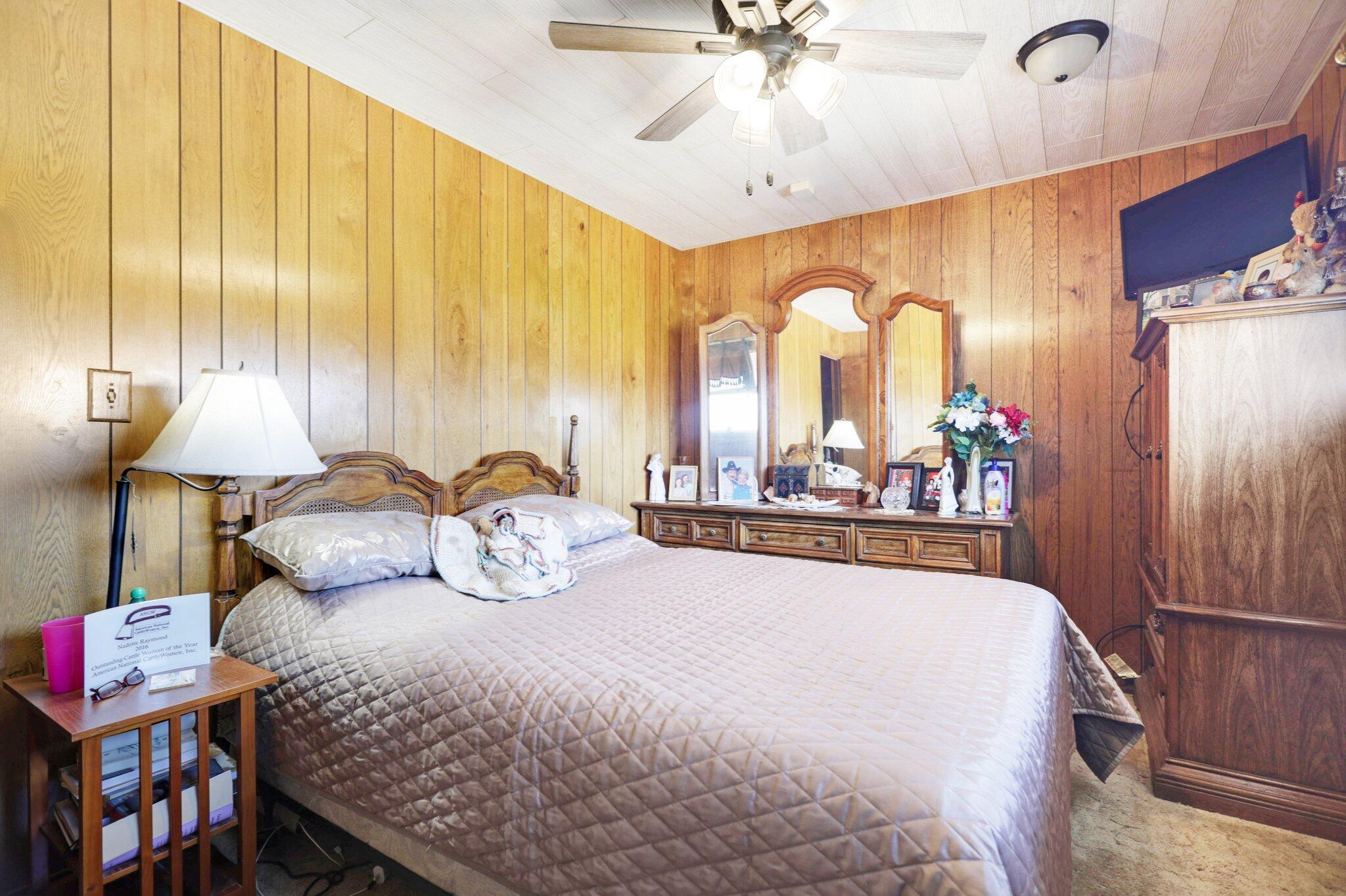 5078 Balls Ferry Road Anderson, CA 96007 - Photo 26 of 113 a bedroom with a bed lamps and a large mirror on the dresser