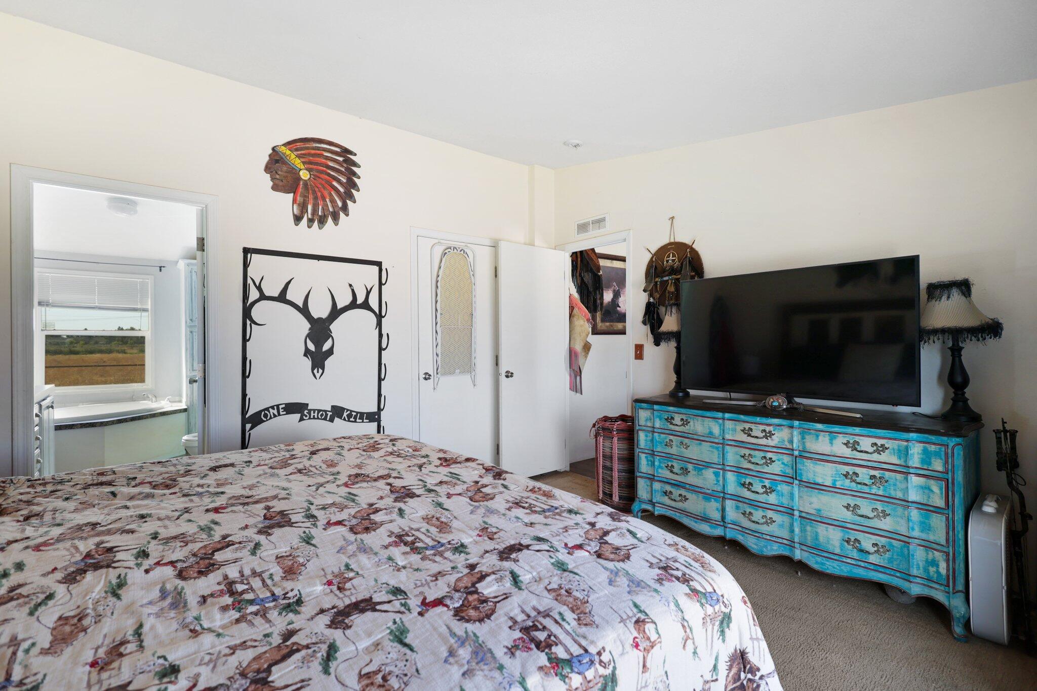5078 Balls Ferry Road Anderson, CA 96007 - Photo 74 of 113 a bedroom with a bed and a flat screen television
