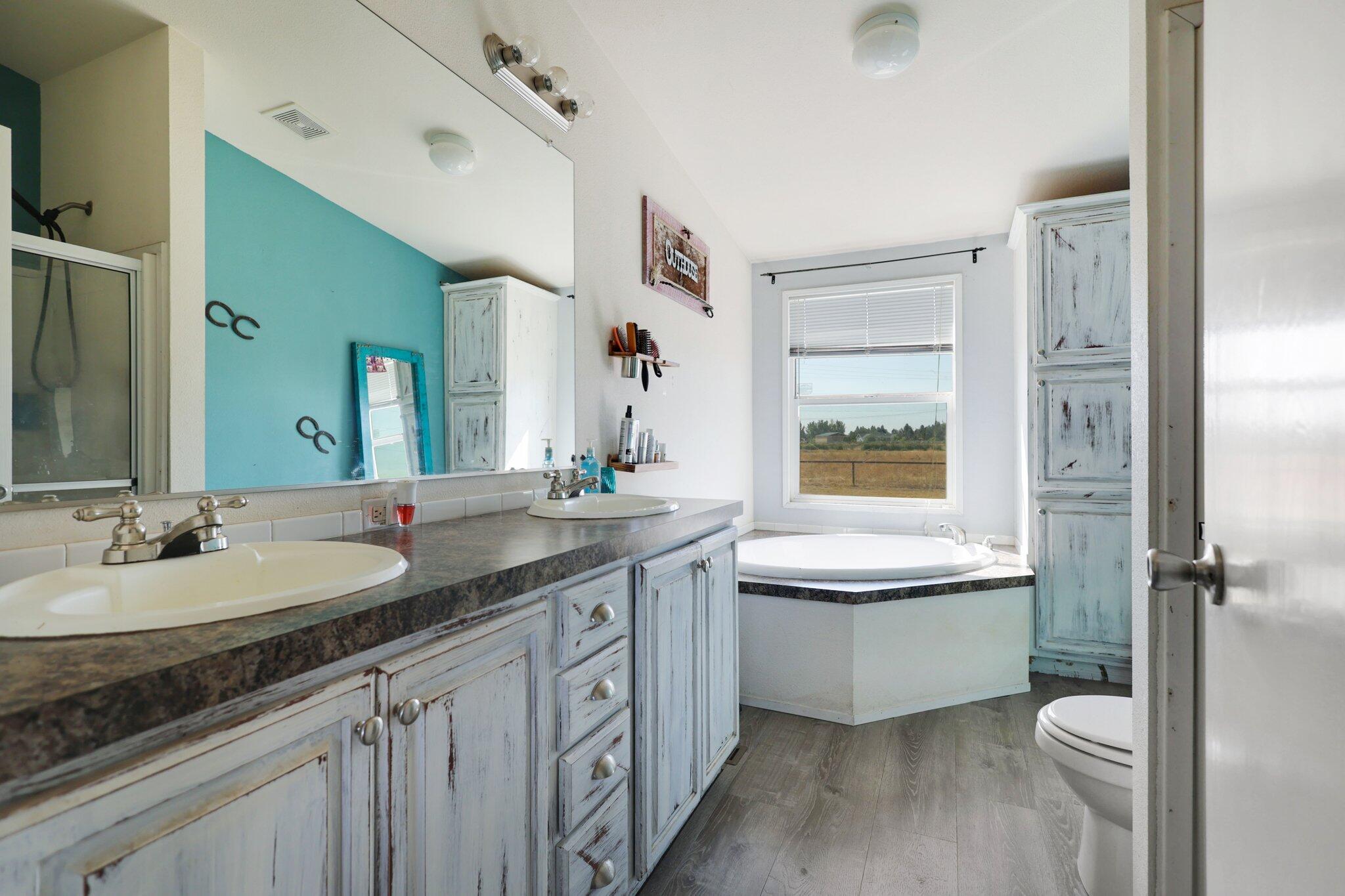 5078 Balls Ferry Road Anderson, CA 96007 - Photo 76 of 113 a bathroom with a granite countertop sink mirror vanity and toilet
