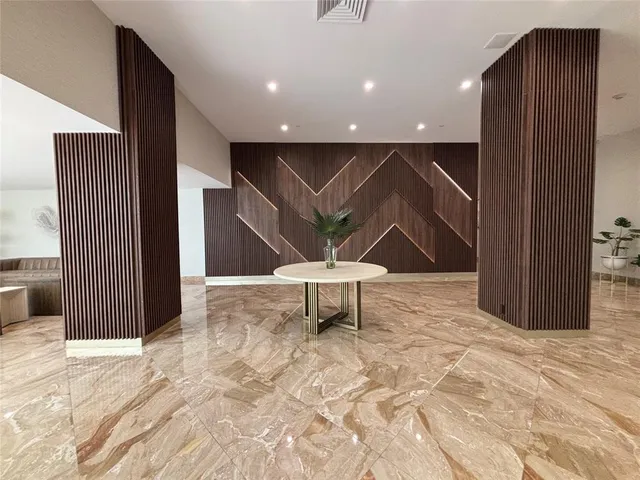 a view of a livingroom with a furniture and floor to ceiling window