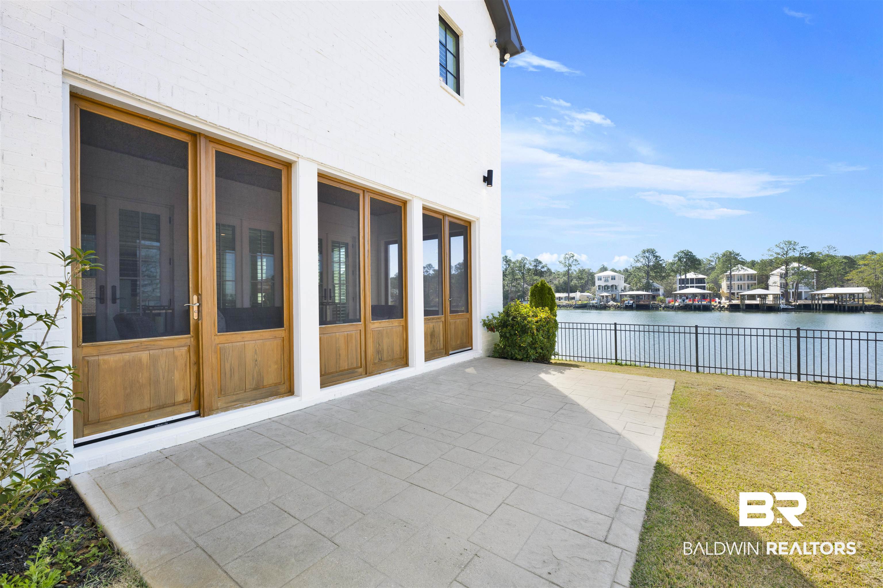 861 Inlet Circle Gulf Shores, AL 36542 - Photo 2 of 54 View of patio featuring a water view and a sunroom